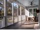 Screened porch features a ceiling fan, outdoor furniture and fireplace at 3365 Westphal Dr, Johns Island, SC 29455