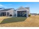Home with screened porch and patio, overlooking yard at 487 Switchgrass Dr, Summerville, SC 29486