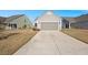 Long driveway leading to a gray house and garage at 487 Switchgrass Dr, Summerville, SC 29486