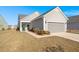 Gray house with attached garage and landscaped front yard at 487 Switchgrass Dr, Summerville, SC 29486