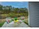 Cozy patio with two chairs and small table, wooded backdrop at 523 Truman Dr, Goose Creek, SC 29445