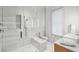Spa-like bathroom with walk-in shower, marble tile, and modern fixtures at 58 Grand Pavilion Blvd, Isle of Palms, SC 29451