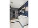 Modern bathroom with navy tile, double vanity, and a walk-in shower at 58 Grand Pavilion Blvd, Isle of Palms, SC 29451