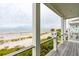 Oceanfront view from deck with white railing, showing beach and ocean at 58 Grand Pavilion Blvd, Isle of Palms, SC 29451