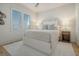 Cozy bedroom with light walls, a queen bed, and a window with shutters at 58 Grand Pavilion Blvd, Isle of Palms, SC 29451