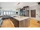 Modern kitchen with large island, marble countertops, and a home elevator at 58 Grand Pavilion Blvd, Isle of Palms, SC 29451