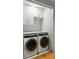 Laundry room with washer and dryer, white cabinets and wood floor at 58 Grand Pavilion Blvd, Isle of Palms, SC 29451