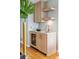 Modern wet bar with light wood cabinets and quartz countertop at 58 Grand Pavilion Blvd, Isle of Palms, SC 29451