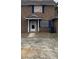 Brick townhouse with boarded windows and a small front yard at 7734 Suzanne Dr, North Charleston, SC 29418