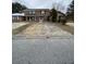 Two-story brick townhouse needing repairs, in a residential neighborhood at 7734 Suzanne Dr, North Charleston, SC 29418