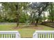 Private backyard with lush landscaping and wooden fence at 8245 Governors Walk, North Charleston, SC 29418