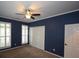 Spacious bedroom with ceiling fan, blue walls, and plenty of closet space at 8245 Governors Walk, North Charleston, SC 29418