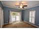 Serene bedroom with sliding glass doors to deck and ceiling fan at 8245 Governors Walk, North Charleston, SC 29418