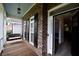 Inviting front porch with a swing and view of the entrance at 8245 Governors Walk, North Charleston, SC 29418