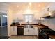 White kitchen cabinets, butcher block countertops, and a farmhouse sink at 8245 Governors Walk, North Charleston, SC 29418