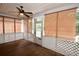 Relaxing screened porch with wood flooring and ceiling fan at 8245 Governors Walk, North Charleston, SC 29418