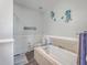 Relaxing bathroom with soaking tub and decorative wall art at 8382 Camp Gregg Ln, North Charleston, SC 29418