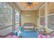 Inviting screened porch, perfect for relaxing with wicker furniture and ceiling fan at 8382 Camp Gregg Ln, North Charleston, SC 29418