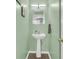 Small powder room with pedestal sink and stylish mirror at 8646 Grassy Oak Trl, North Charleston, SC 29420