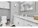Bathroom with granite countertop, white cabinets, and a large mirror at 8646 Grassy Oak Trl, North Charleston, SC 29420
