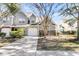 Two-story townhome with brick and siding exterior, attached garage, and landscaped yard at 8646 Grassy Oak Trl, North Charleston, SC 29420