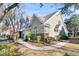 Tan and green two story townhome with a nicely landscaped yard and walkway at 8646 Grassy Oak Trl, North Charleston, SC 29420
