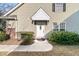 White front door with a charming wreath, and well maintained landscaping at 8646 Grassy Oak Trl, North Charleston, SC 29420