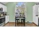 Bright kitchen with white cabinets, stainless steel appliances, and breakfast bar at 8646 Grassy Oak Trl, North Charleston, SC 29420