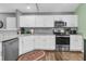 Modern kitchen with white cabinets, granite countertops, and stainless steel appliances at 8646 Grassy Oak Trl, North Charleston, SC 29420