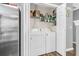 Convenient laundry closet with washer, dryer, and storage shelves at 8646 Grassy Oak Trl, North Charleston, SC 29420