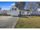 Tan house with a garage and patio, situated on a grassy lot at 9609 Crosscut Dr, Ladson, SC 29456