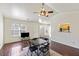 Living room with hardwood floors, ceiling fan, and kitchen view at 9609 Crosscut Dr, Ladson, SC 29456