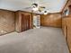 Large bedroom with wood paneling, ceiling fans, and access to upper level at 119 Sumners Aly, Summerville, SC 29485