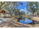 Serene community pond reflecting homes and lush trees at 1442 Eutaw Battalion Dr, Charleston, SC 29412