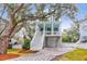 Two-story light blue house with white trim, a front porch, and a landscaped yard at 1442 Eutaw Battalion Dr, Charleston, SC 29412