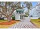 Two-story light blue house with white trim, a front porch, and a landscaped yard at 1442 Eutaw Battalion Dr, Charleston, SC 29412