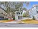 Two-story light blue house with white trim, a front porch, and a landscaped yard at 1442 Eutaw Battalion Dr, Charleston, SC 29412