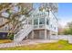 Two-story light blue house with white trim, a front porch, and a landscaped yard at 1442 Eutaw Battalion Dr, Charleston, SC 29412