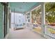 Relaxing front porch with a swing and seating area, offering a view of the neighborhood at 1442 Eutaw Battalion Dr, Charleston, SC 29412