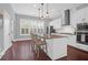 Modern kitchen with white cabinets, granite countertops and island, stainless steel appliances at 1442 Eutaw Battalion Dr, Charleston, SC 29412