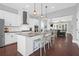 Open concept kitchen with white cabinets, granite countertops, island and stainless steel appliances at 1442 Eutaw Battalion Dr, Charleston, SC 29412