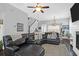 Spacious living room with a large sectional sofa and fireplace, hardwood floors and lots of natural light at 1442 Eutaw Battalion Dr, Charleston, SC 29412