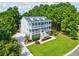 Two-story house with large backyard and driveway, surrounded by lush green trees at 1504 Rivertowne Country Club Dr, Mount Pleasant, SC 29466