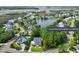 Attractive neighborhood with lake, showcasing a two story house with large yard at 1504 Rivertowne Country Club Dr, Mount Pleasant, SC 29466