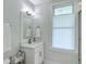 Bright bathroom with a single sink vanity and a large window at 1504 Rivertowne Country Club Dr, Mount Pleasant, SC 29466
