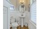 Charming powder room with pedestal sink and window at 1504 Rivertowne Country Club Dr, Mount Pleasant, SC 29466