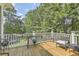 Spacious deck overlooking a backyard with trees and a trampoline at 1504 Rivertowne Country Club Dr, Mount Pleasant, SC 29466