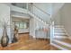 Two-story foyer with hardwood floors, elegant staircase, and decorative accents at 1504 Rivertowne Country Club Dr, Mount Pleasant, SC 29466