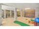 Spacious game room with basketball hoop, golf simulator, and exercise equipment at 1504 Rivertowne Country Club Dr, Mount Pleasant, SC 29466
