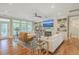 Bright living room with fireplace, hardwood floors, and access to balcony at 1504 Rivertowne Country Club Dr, Mount Pleasant, SC 29466